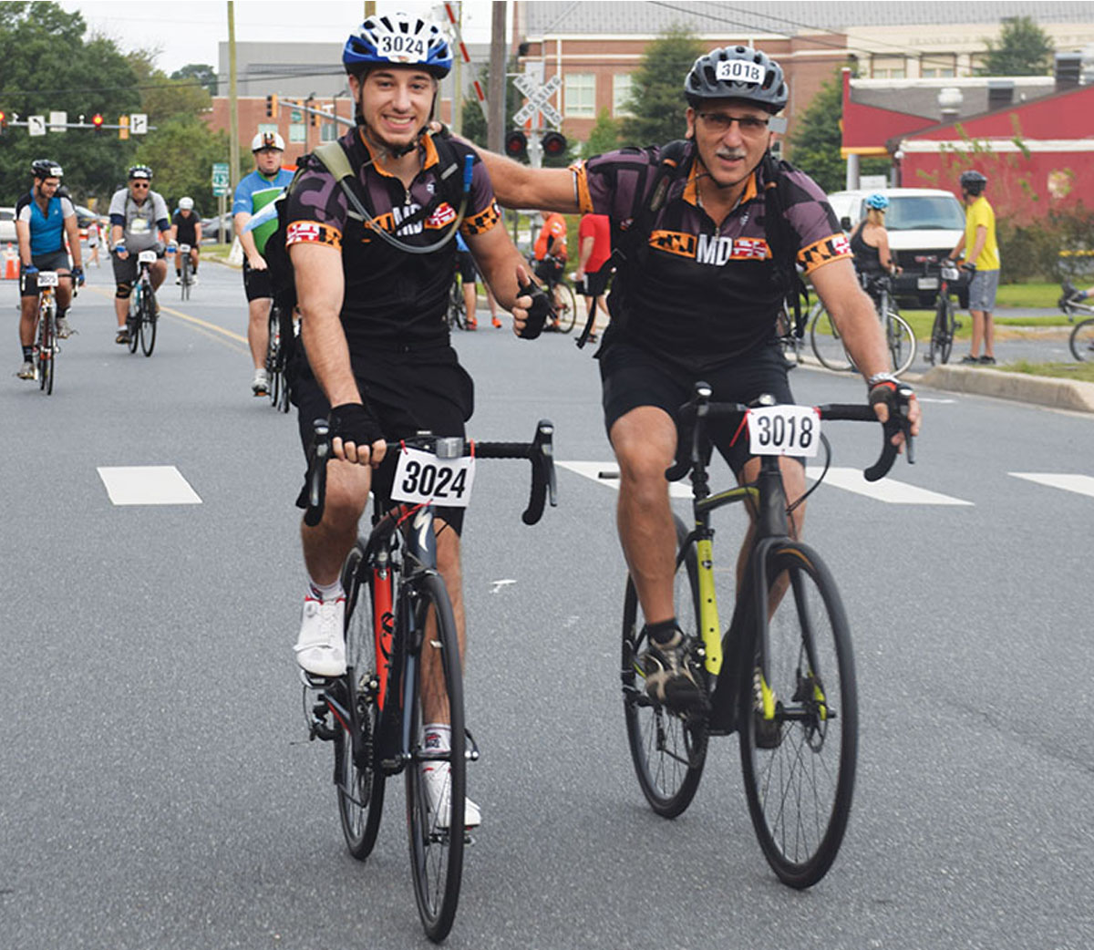 Two bicyclists smiling 